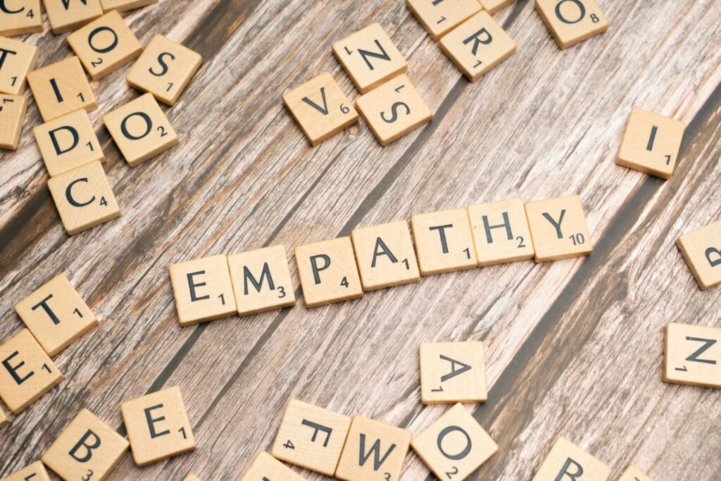 scrabble tiles spelling the word sympathy on a wooden surface