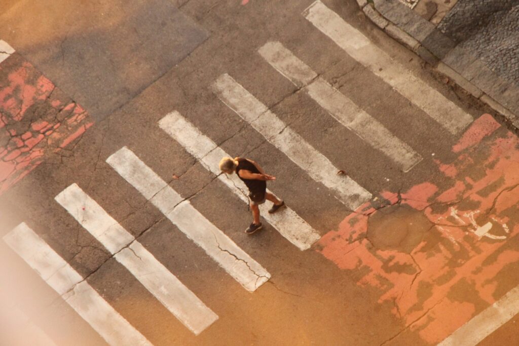 An aerial view of a person crossing a street
